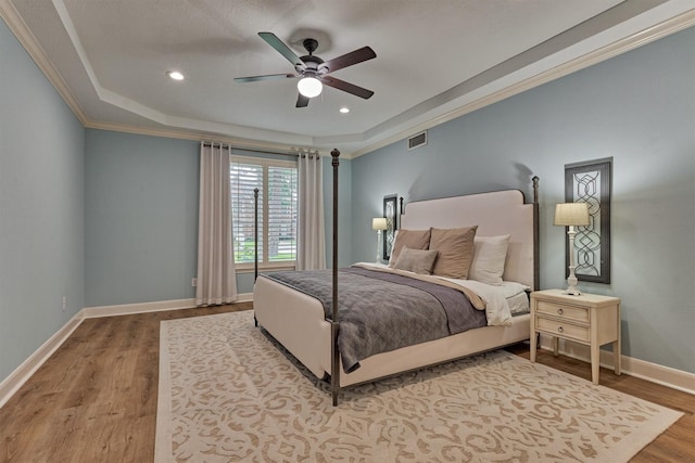 23119 Hampton Forest Ln, Spring, TX 77389 - bedroom with wood finished floors, a raised ceiling, ornamental molding, recessed lighting, and a ceiling fan