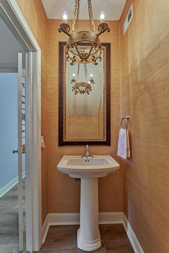 23119 Hampton Forest Ln, Spring, TX 77389 - bathroom featuring a chandelier and wood finished floors