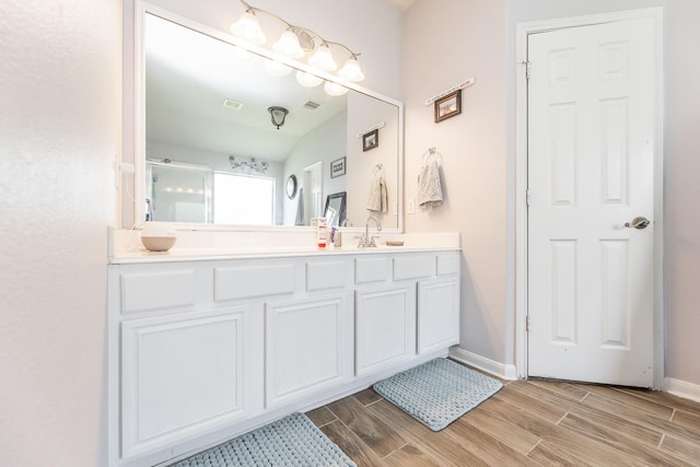 8114 Rushing Stream Ct, Tomball, TX 77375 - bathroom featuring wood tiled floors, vanity, and an enclosed shower