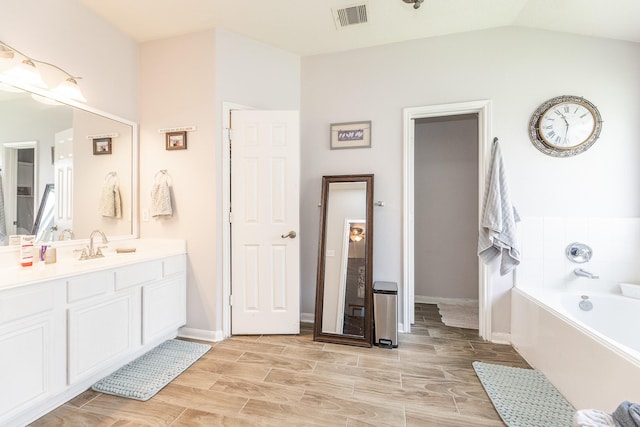8114 Rushing Stream Ct, Tomball, TX 77375 - full bath with vanity, a garden tub, wood tiled floors, and lofted ceiling
