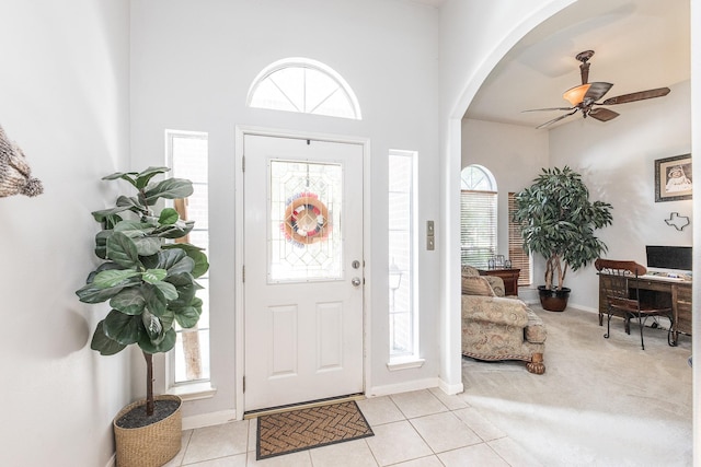 8114 Rushing Stream Ct, Tomball, TX 77375 - foyer with healthy amount of natural light, arched walkways, a ceiling fan, a towering ceiling, and light tile patterned floors