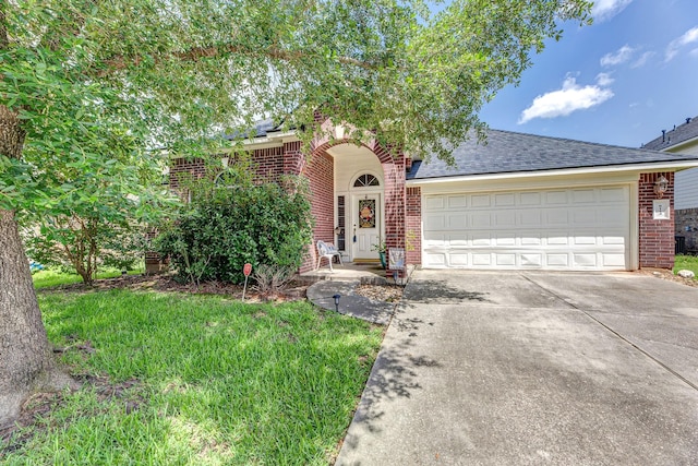8114 Rushing Stream Ct, Tomball, TX 77375 - view of front of house with brick siding, driveway, a shingled roof, and an attached garage