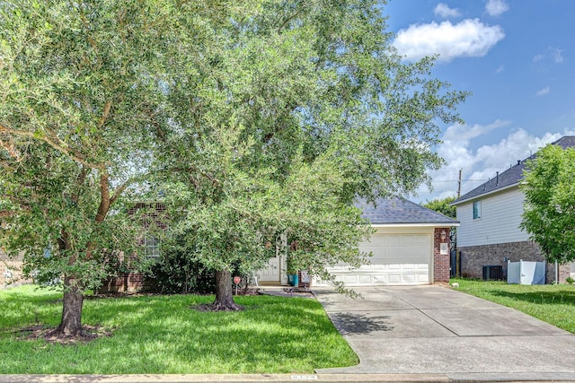 8114 Rushing Stream Ct, Tomball, TX 77375 - obstructed view of property with concrete driveway, an attached garage, a front yard, and a shingled roof