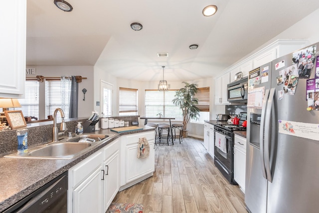 8114 Rushing Stream Ct, Tomball, TX 77375 - kitchen featuring black appliances, dark countertops, white cabinets, light wood-type flooring, and pendant lighting