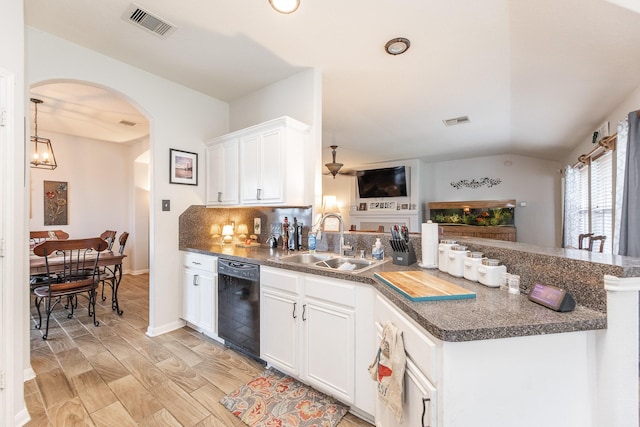 8114 Rushing Stream Ct, Tomball, TX 77375 - kitchen with dishwasher, a peninsula, arched walkways, dark countertops, and white cabinetry