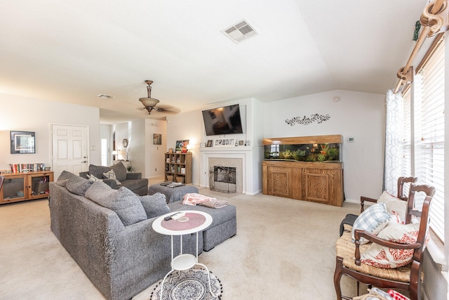 8114 Rushing Stream Ct, Tomball, TX 77375 - living area with light carpet, lofted ceiling, ceiling fan, and a tile fireplace