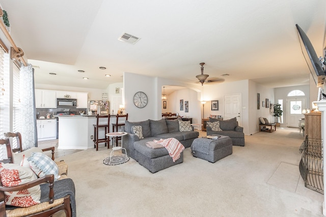 8114 Rushing Stream Ct, Tomball, TX 77375 - living area featuring light colored carpet, a ceiling fan, and arched walkways