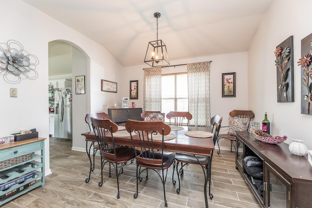 8114 Rushing Stream Ct, Tomball, TX 77375 - dining space with lofted ceiling, arched walkways, and wood finish floors
