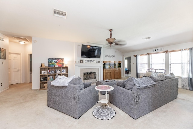 8114 Rushing Stream Ct, Tomball, TX 77375 - living room featuring a ceiling fan, a tile fireplace, and light carpet