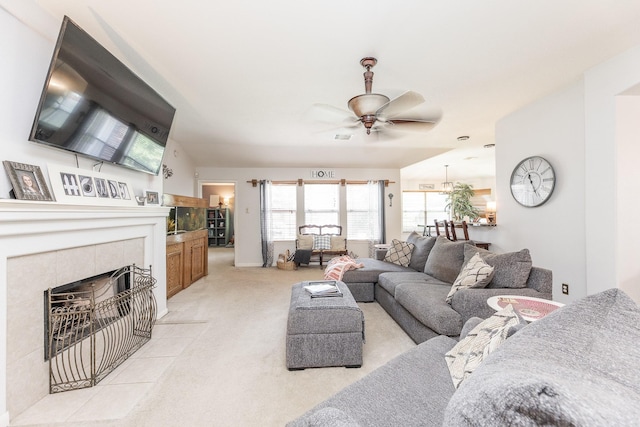 8114 Rushing Stream Ct, Tomball, TX 77375 - living area featuring ceiling fan, light colored carpet, and a tiled fireplace