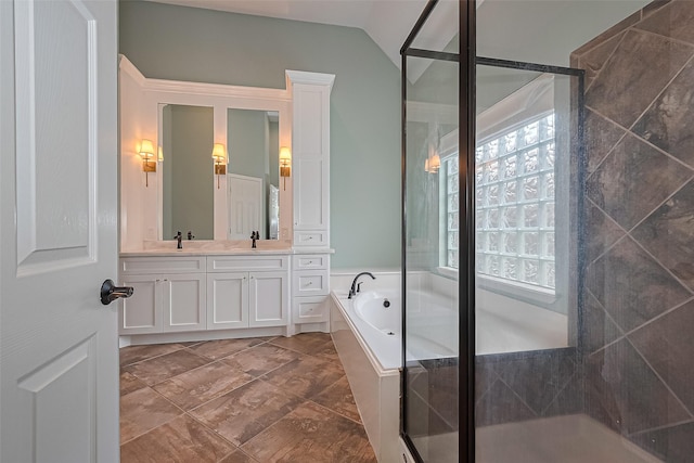 3631 Rocky Ledge Ln, Katy, TX 77494 - full bathroom with double vanity, a bath, a stall shower, and lofted ceiling