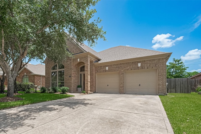 3631 Rocky Ledge Ln, Katy, TX 77494 - view of front of house featuring brick siding, an attached garage, driveway, and a shingled roof