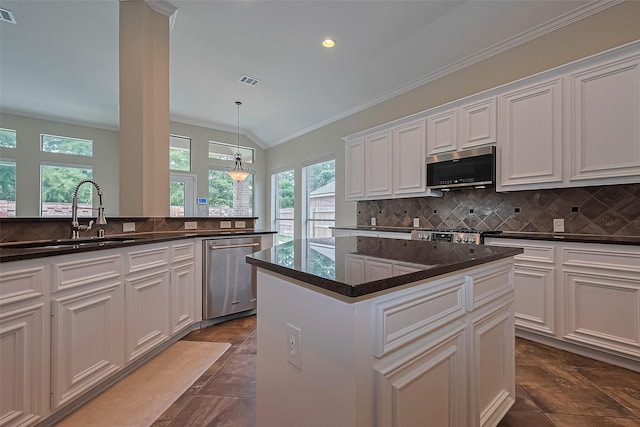 3631 Rocky Ledge Ln, Katy, TX 77494 - kitchen featuring appliances with stainless steel finishes, ornamental molding, decorative backsplash, white cabinetry, and a kitchen island