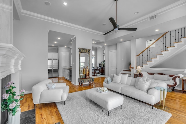 2206 Hilshire Glen Ct, Houston, TX 77080 - living room with ornamental molding, ceiling fan, light wood-type flooring, stairs, and recessed lighting