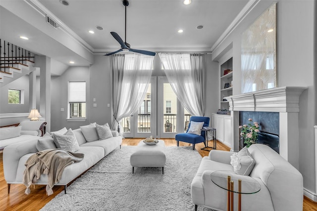 2206 Hilshire Glen Ct, Houston, TX 77080 - living room with crown molding, ceiling fan, wood finished floors, recessed lighting, and stairs
