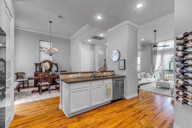 2206 Hilshire Glen Ct, Houston, TX 77080 - kitchen featuring dishwasher, ornamental molding, light wood-style flooring, white cabinetry, and dark stone countertops