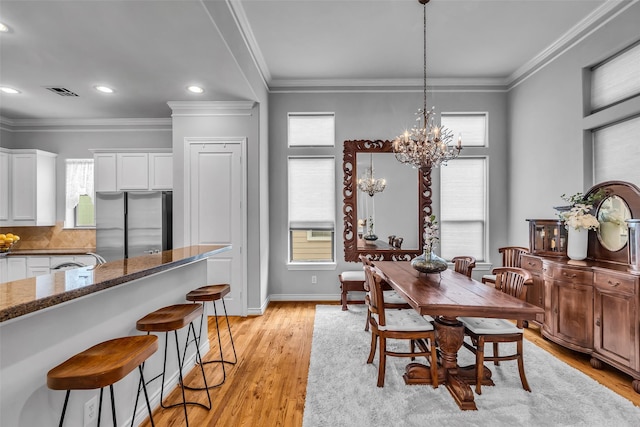 2206 Hilshire Glen Ct, Houston, TX 77080 - dining room featuring recessed lighting, a chandelier, light wood-style flooring, and crown molding