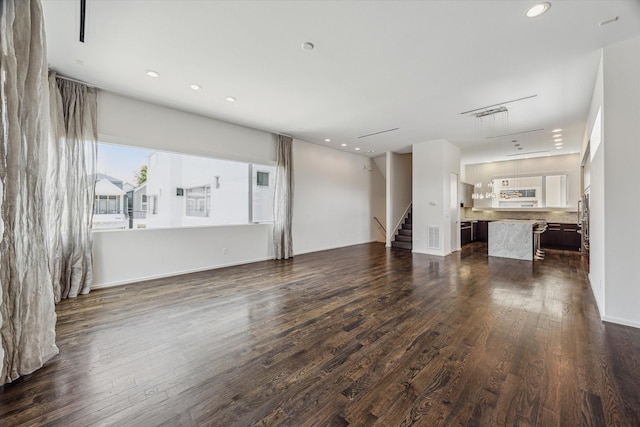 1728 Michigan St Unit C, Houston, TX 77006 - unfurnished living room featuring dark wood-style floors, stairs, and recessed lighting