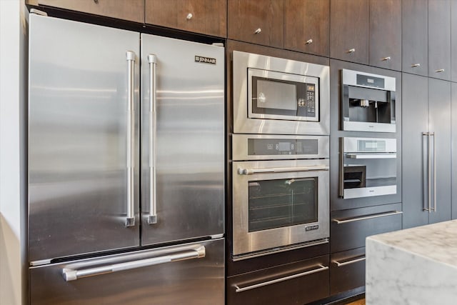 1728 Michigan St Unit C, Houston, TX 77006 - kitchen with appliances with stainless steel finishes and dark brown cabinetry