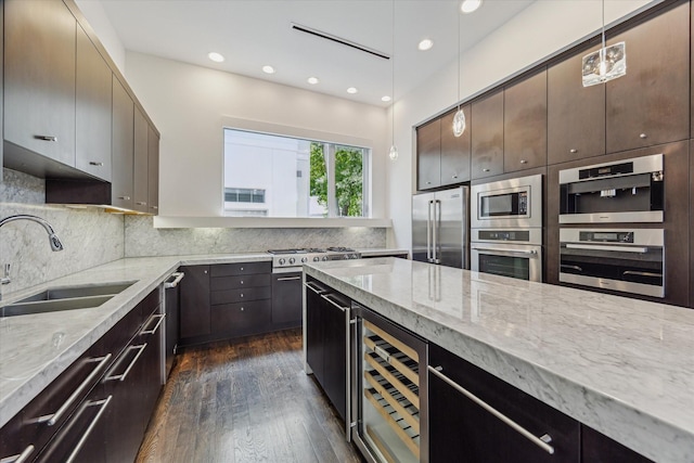 1728 Michigan St Unit C, Houston, TX 77006 - kitchen with wine cooler, stainless steel appliances, light stone counters, dark wood-type flooring, and backsplash