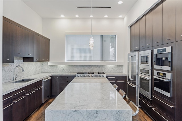 1728 Michigan St Unit C, Houston, TX 77006 - kitchen with a kitchen island, dark wood-style floors, appliances with stainless steel finishes, modern cabinets, and recessed lighting