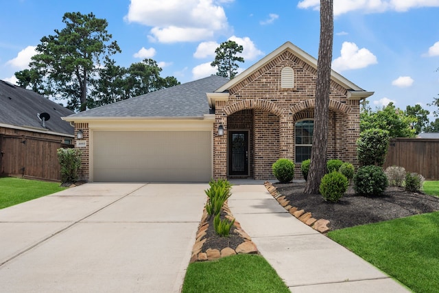 16863 Big Reed Dr, Humble, TX 77346 - view of front of house featuring brick siding, an attached garage, concrete driveway, and roof with shingles