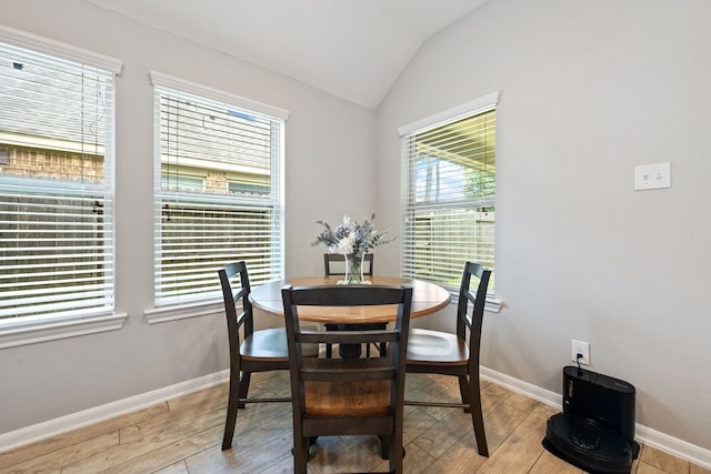 16863 Big Reed Dr, Humble, TX 77346 - dining room featuring light wood finished floors and vaulted ceiling