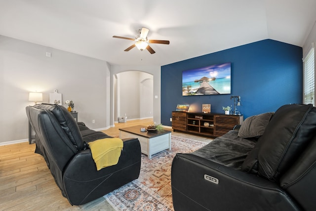 16863 Big Reed Dr, Humble, TX 77346 - living area with arched walkways, a ceiling fan, light wood-style floors, and vaulted ceiling