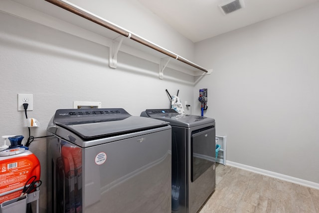 16863 Big Reed Dr, Humble, TX 77346 - laundry area featuring washing machine and clothes dryer and light wood-style floors