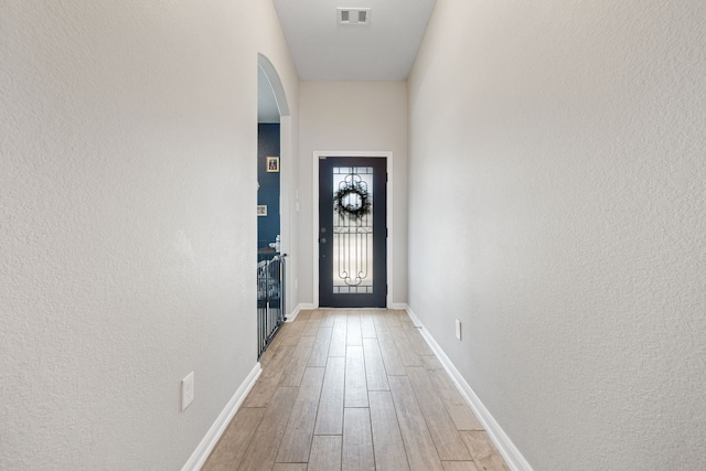 16863 Big Reed Dr, Humble, TX 77346 - entryway with arched walkways, light wood-style floors, and a textured wall