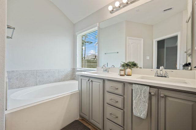 16863 Big Reed Dr, Humble, TX 77346 - full bath with double vanity, a garden tub, and vaulted ceiling