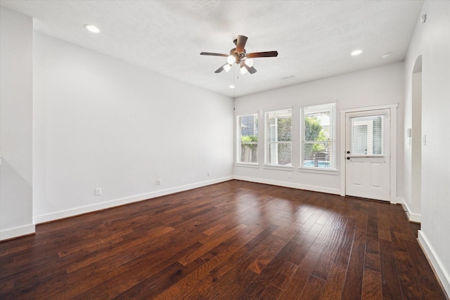 17011 Seminole Ridge Dr, Cypress, TX 77433 - unfurnished room with arched walkways, dark wood finished floors, a ceiling fan, and recessed lighting