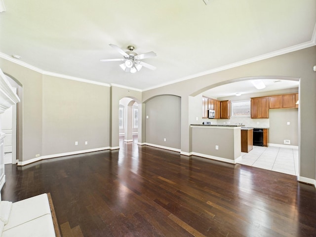 8122 Silver Lure Dr, Humble, TX 77346 - unfurnished living room featuring ceiling fan, light wood-style flooring, ornamental molding, and arched walkways