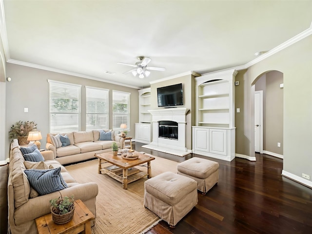 8122 Silver Lure Dr, Humble, TX 77346 - living room with arched walkways, a ceiling fan, crown molding, wood finished floors, and a tiled fireplace