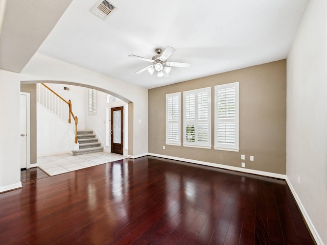 8122 Silver Lure Dr, Humble, TX 77346 - unfurnished living room featuring arched walkways, a ceiling fan, stairway, and hardwood / wood-style flooring
