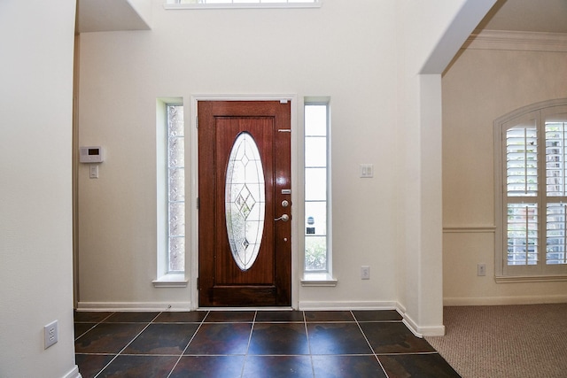 150 Nina Ln, Stafford, TX 77477 - foyer entrance with plenty of natural light and dark tile patterned flooring