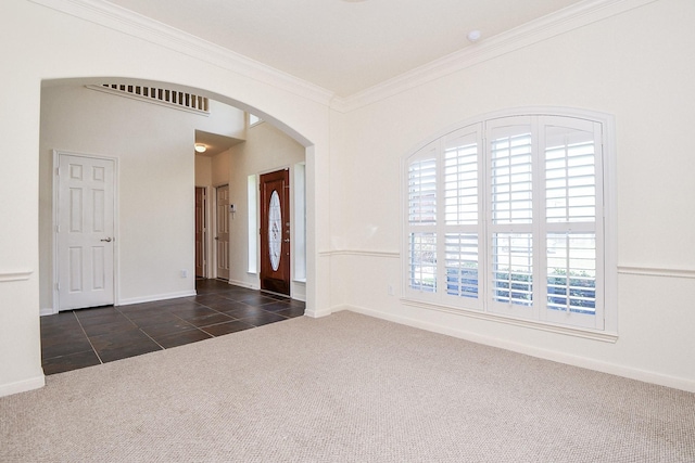 150 Nina Ln, Stafford, TX 77477 - foyer entrance with dark carpet, arched walkways, ornamental molding, and dark tile patterned flooring