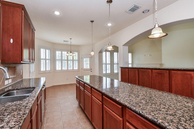 150 Nina Ln, Stafford, TX 77477 - kitchen featuring healthy amount of natural light, stainless steel dishwasher, pendant lighting, light tile patterned floors, and recessed lighting