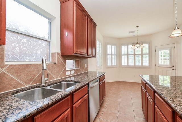 150 Nina Ln, Stafford, TX 77477 - kitchen featuring stainless steel dishwasher, a chandelier, tasteful backsplash, pendant lighting, and dark stone counters