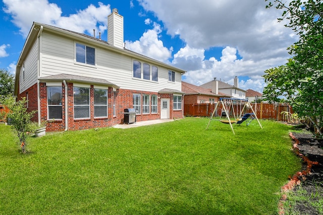 150 Nina Ln, Stafford, TX 77477 - back of house with a playground, brick siding, a fenced backyard, a chimney, and a patio area