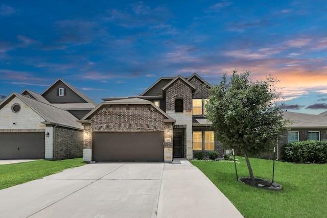 3619 Barkers Run Dr, Houston, TX 77084 - view of front facade with stone siding, brick siding, a lawn, driveway, and a garage