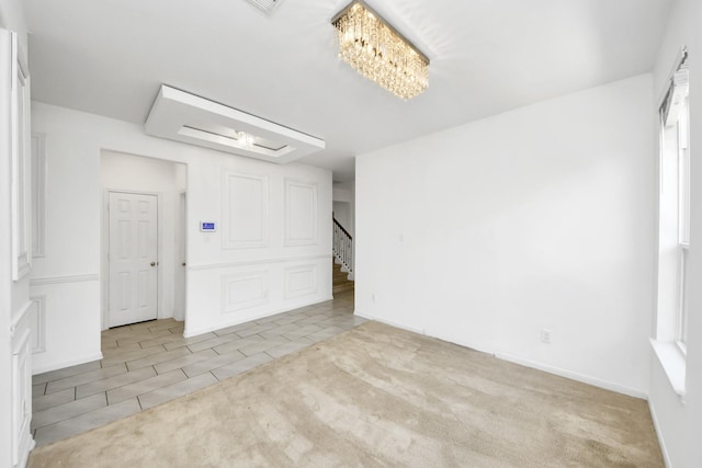 3619 Barkers Run Dr, Houston, TX 77084 - carpeted empty room featuring a chandelier, tile patterned flooring, and stairway