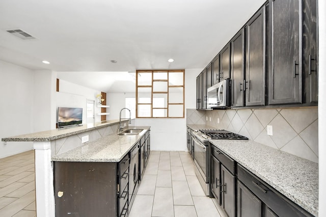 3619 Barkers Run Dr, Houston, TX 77084 - kitchen with appliances with stainless steel finishes, tasteful backsplash, recessed lighting, light stone countertops, and light tile patterned floors