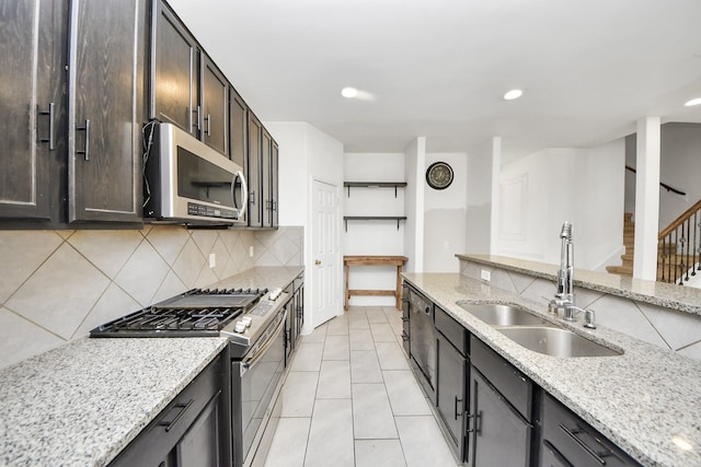 3619 Barkers Run Dr, Houston, TX 77084 - kitchen featuring stainless steel appliances, decorative backsplash, light stone counters, light tile patterned floors, and recessed lighting