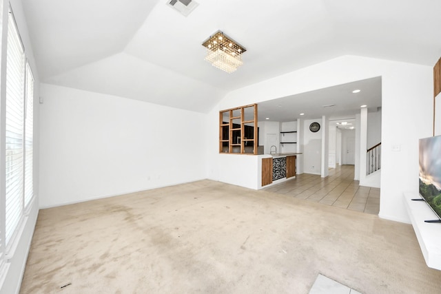 3619 Barkers Run Dr, Houston, TX 77084 - unfurnished living room featuring vaulted ceiling, light carpet, healthy amount of natural light, a chandelier, and stairs