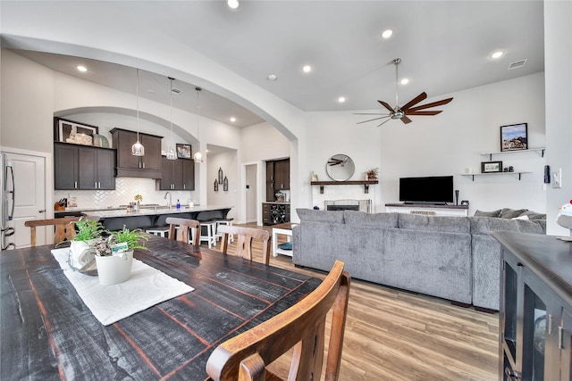 4327 Sage Glen Ln, Fulshear, TX 77441 - dining room featuring ceiling fan, vaulted ceiling, light wood-style flooring, recessed lighting, and arched walkways