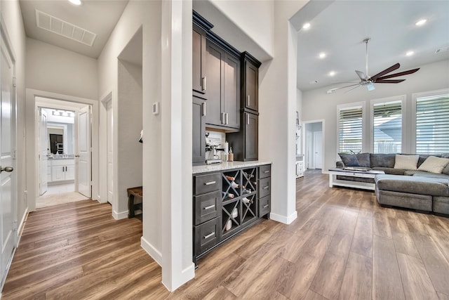 4327 Sage Glen Ln, Fulshear, TX 77441 - bar area featuring light wood-style flooring, a ceiling fan, and recessed lighting