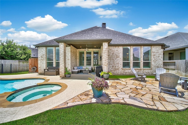 4327 Sage Glen Ln, Fulshear, TX 77441 - rear view of house with an in-ground hot tub, outdoor lounge area, a patio, and brick siding