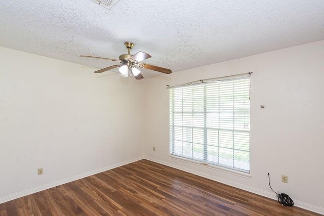 8111 Dellanera Dr, Hitchcock, TX 77563 - unfurnished room with dark wood-style flooring, a ceiling fan, and a textured ceiling