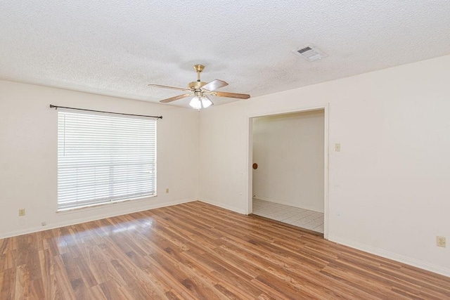 8111 Dellanera Dr, Hitchcock, TX 77563 - empty room with ceiling fan, wood finished floors, and a textured ceiling